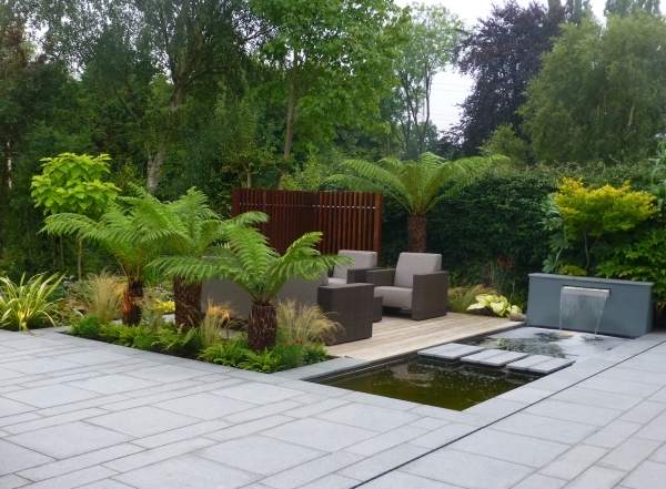 Garden seating area with waterfall and pond