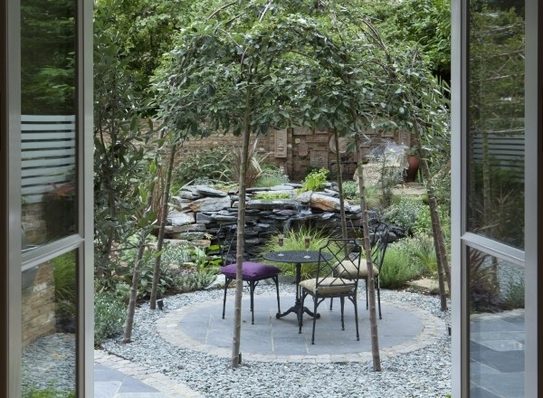 Secret garden atmosphere with decorative trees and garden pond by Sara Jane, landscape designer on Design for Me