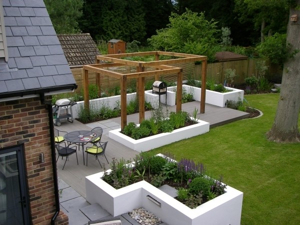 Spacious garden design with concrete and wooden paving by James, landscape designer on Design for Me