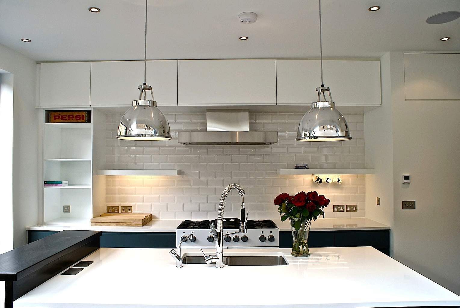 Kitchen design with pendant light and white walls