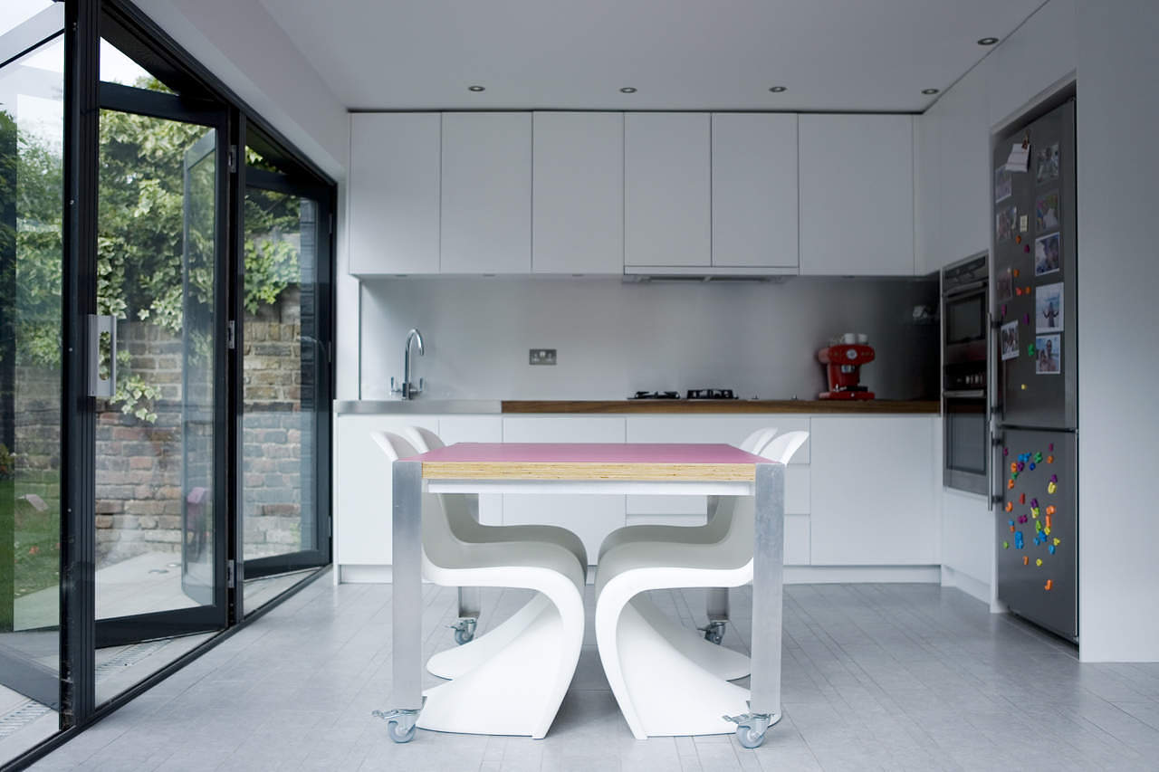 Kitchen in an extension with white table and clear flooring by Rebecca, architect on Design for Me.